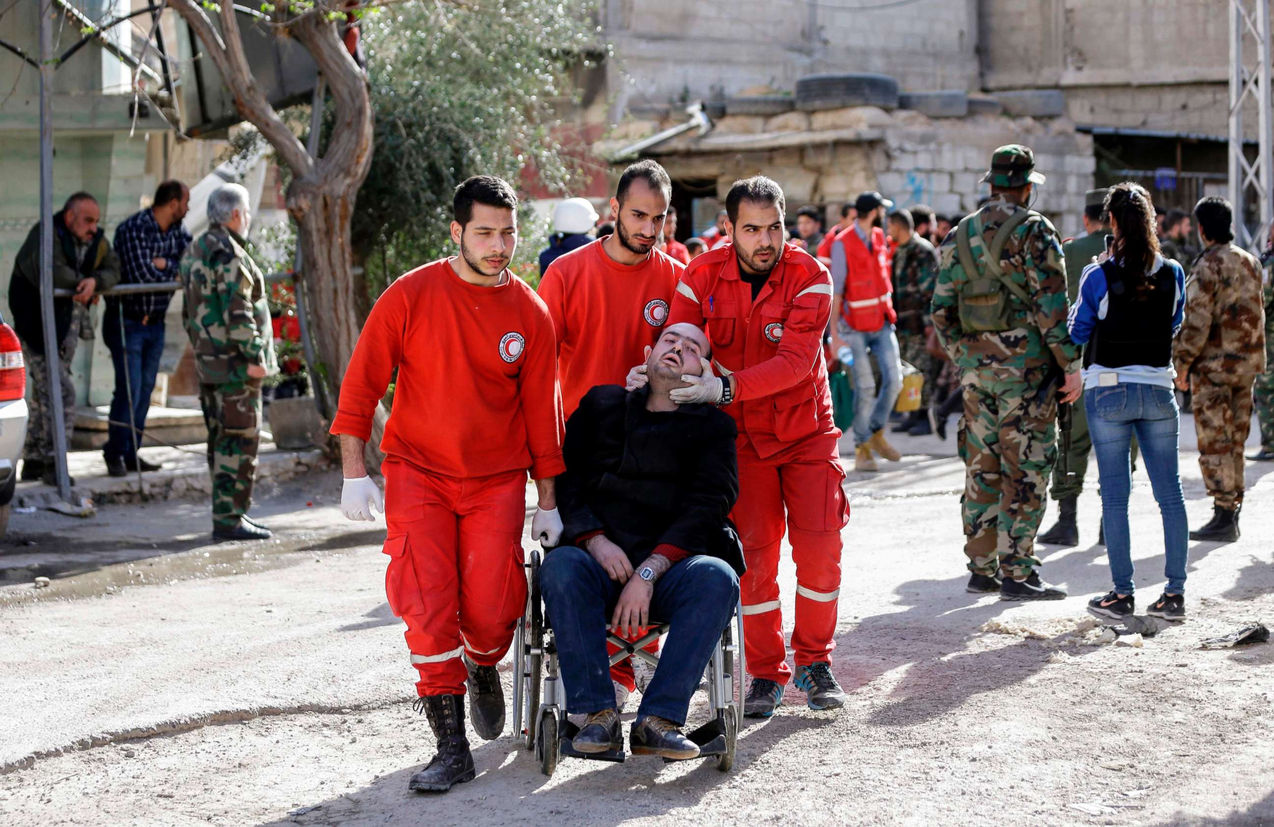 PHOTO: Members of the Syrian Red Crescent help evacuate an injured man into the government side of the Wafideen checkpoint on the outskirts of Damascus, March 14, 2018.
