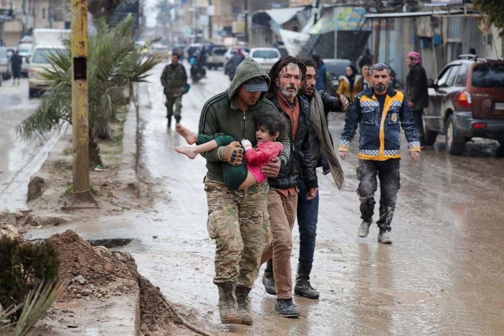 PHOTO: A girl is carried following an earthquake, in rebel-held town of Jandaris, Syria Feb. 6, 2023.