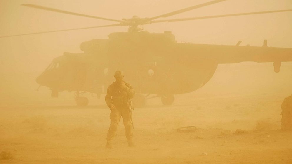 A Russian soldier guards as a military helicopter takes off at an airport in Deir eI-Zor, Syria, Sept. 15, 2017. 