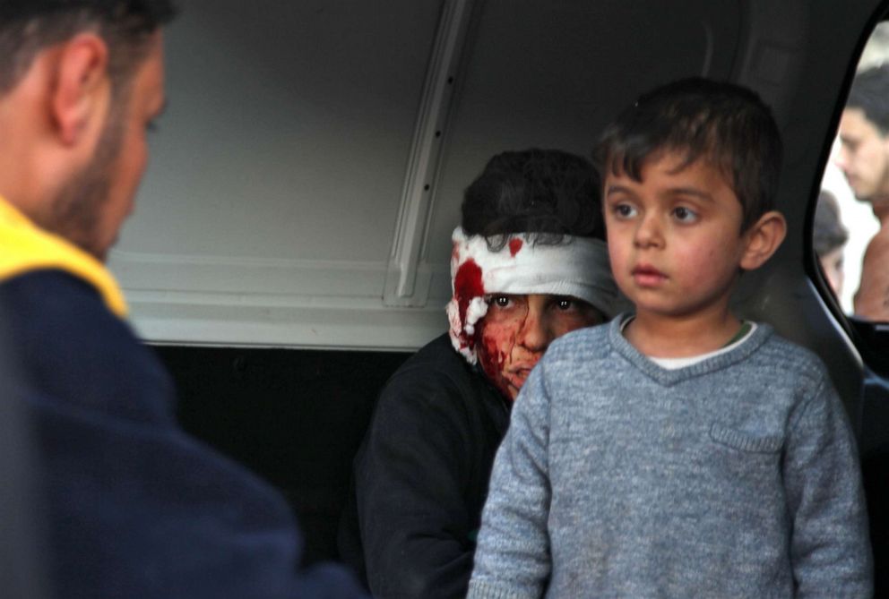 PHOTO: Syrian children sit inside a vehicle as they are evacuated from the scene of a pro-regime forces air strike in Maarrat Misrin in Idlib, Syria, Feb. 25, 2020.