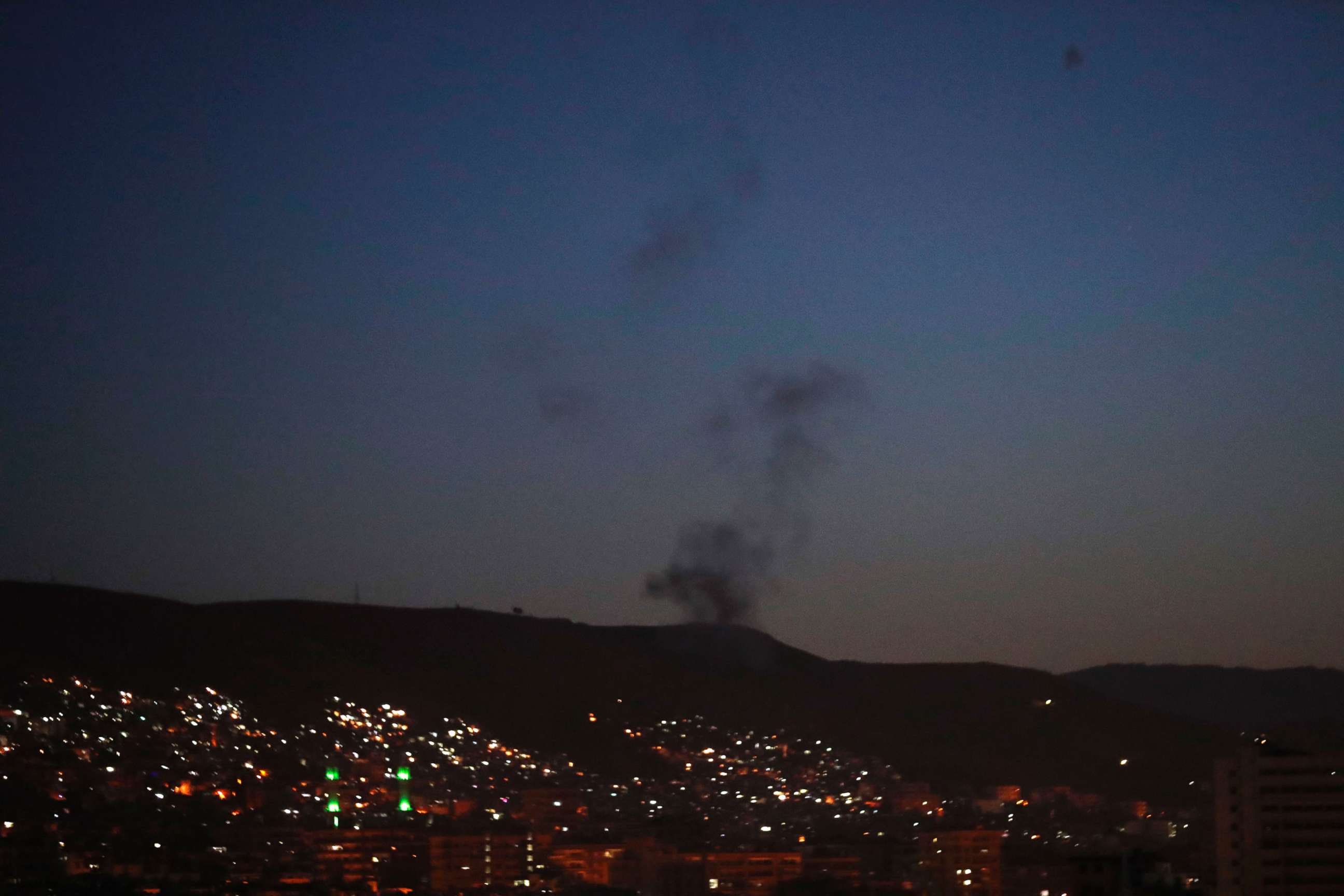 PHOTO: Smoke rises after airstrikes in parts of the Syrian capital Damascus, early Saturday, April 14, 2018.