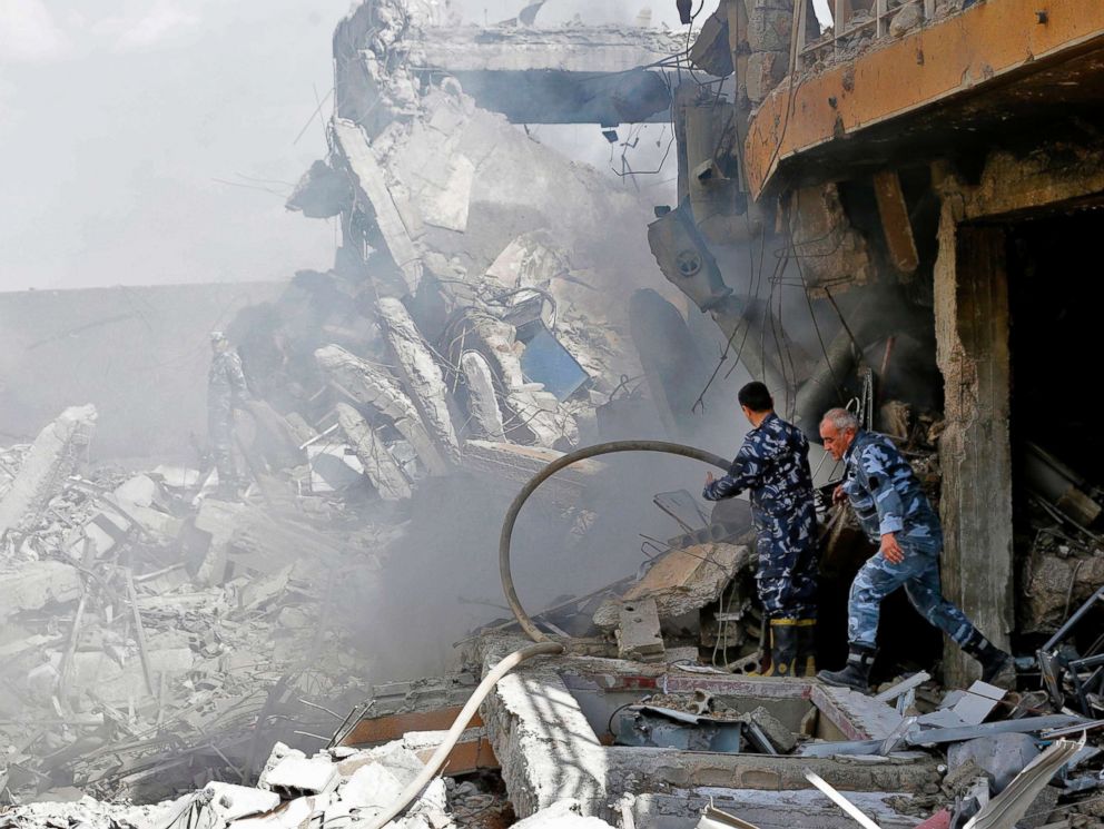 PHOTO: Syrian soldiers inspect the wreckage of a building described as part of the Scientific Studies and Research Center (SSRC) compound in Barzeh, north of Damascus, Syria, April 14, 2018.