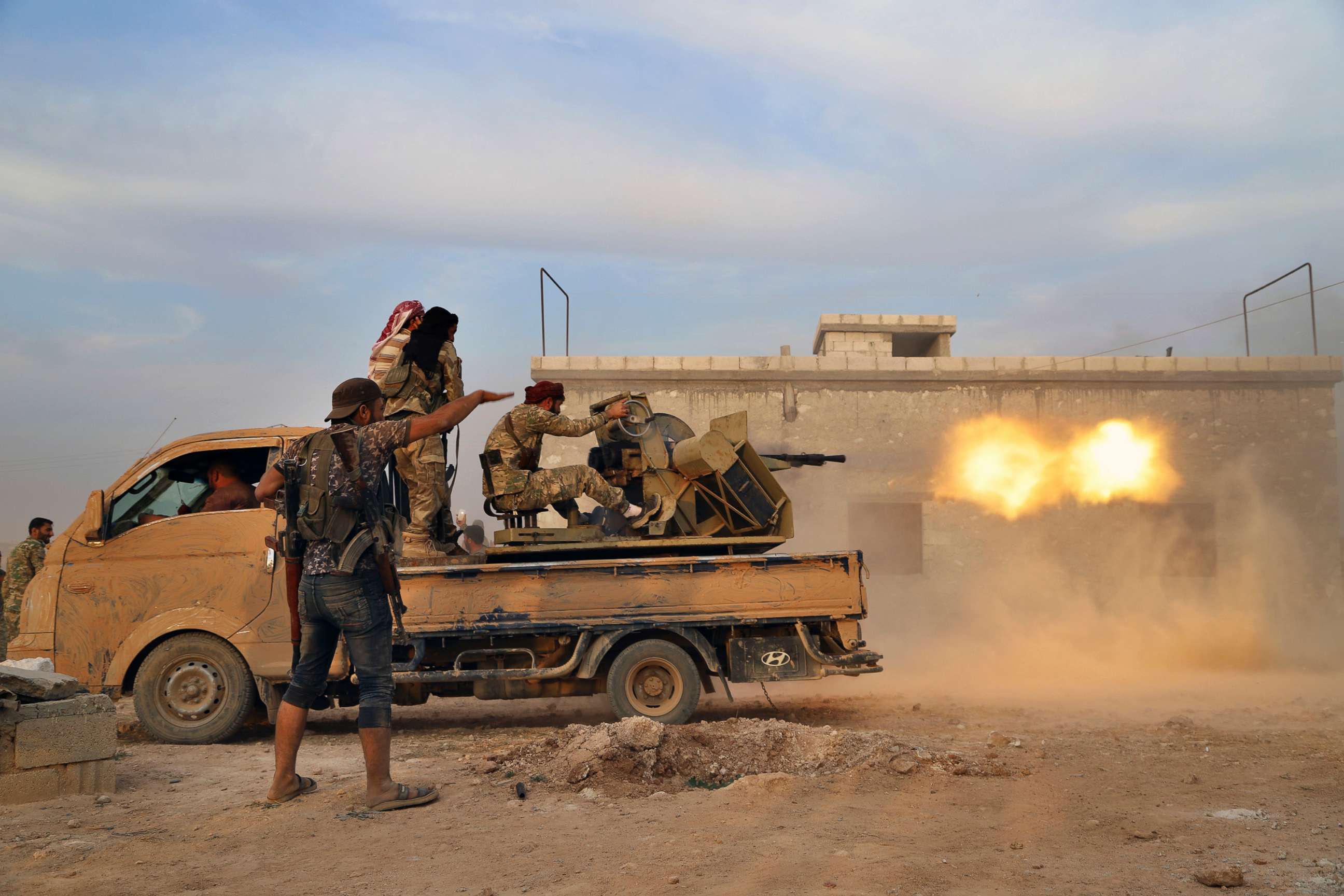 PHOTO: Turkey-backed Syrian opposition fighters fire a heavy machine-gun towards Kurdish fighters, in Syria's northern region of Manbij on Oct. 14, 2019.