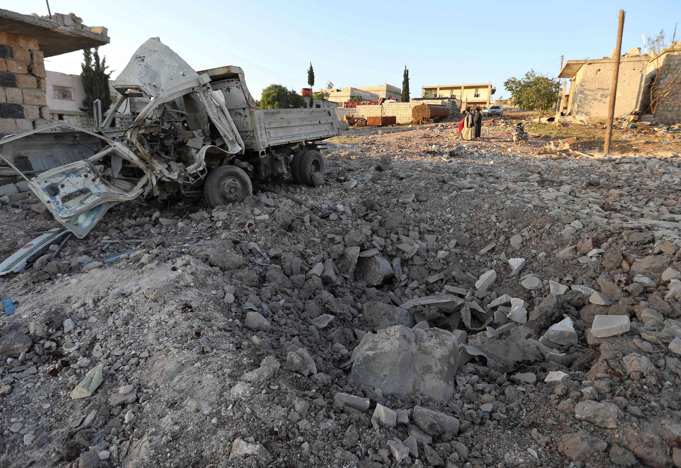 PHOTO: A damaged vehicle lies next to a crater cased by reported airstrikes by the Syrian regime ally Russia, in the town of Kafranbel in the rebel-held part of the Syrian Idlib province on May 20, 2019.