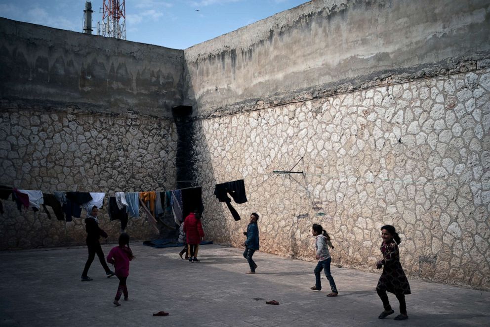 PHOTO: Children play inside Idlib's old central prison, now transformed into a camp for people displaced by fighting, in Idlib, Syria, March 12, 2020.