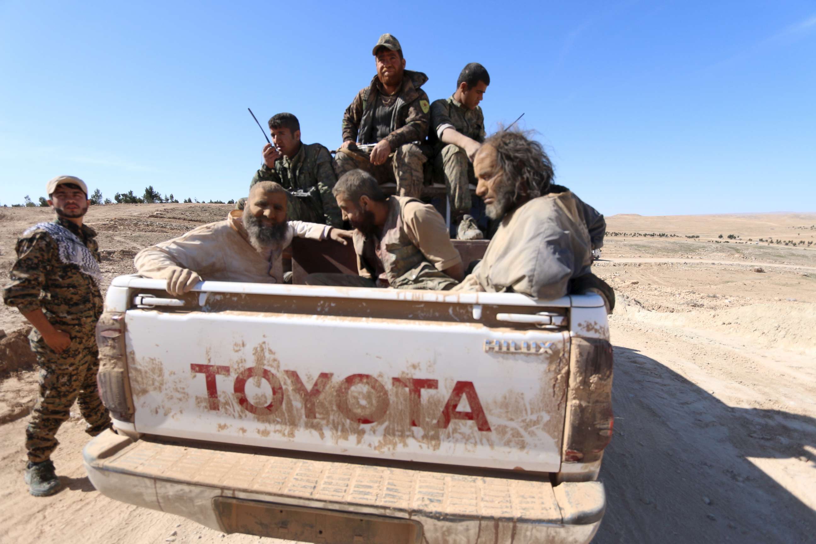 PHOTO: Three men that Democratic Forces of Syria fighters claimed were Islamic State fighters sit on a pick-up truck while being held as prisoners, near al-Shadadi town, Hasaka countryside, Syria, Feb. 18, 2016.