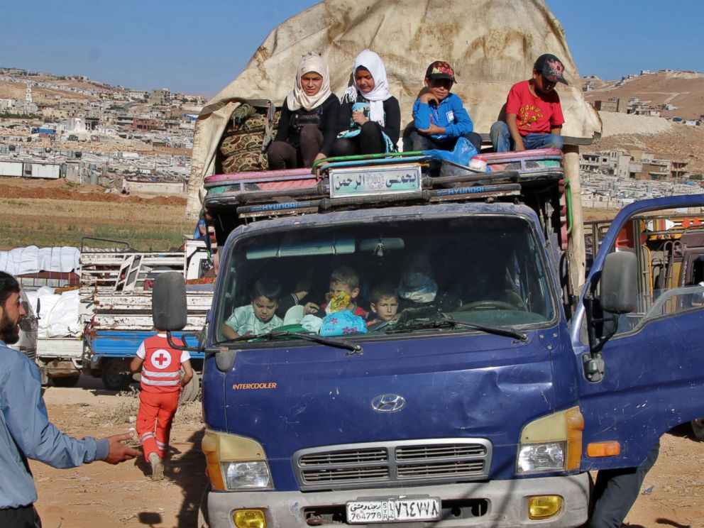 PHOTO: Syrian refugees ride a truck carrying their personal belongings at a Lebanese army checkpoint in Wadi Hmeid in the Bekaa valley, after leaving the village of Arsal to return to their homes in Syrias Qalamoun region on July 23, 2018.