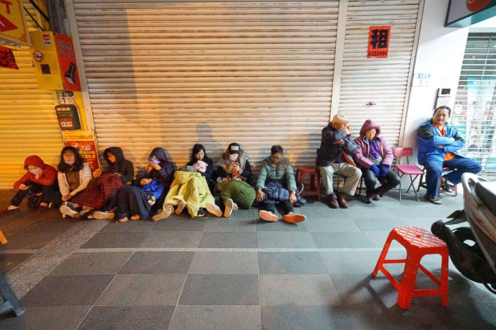 PHOTO: Customers who escaped from the damaged Marshal Hotel take shelter in Hualien, eastern Taiwan, after a strong quake on Feb. 7, 2018. 