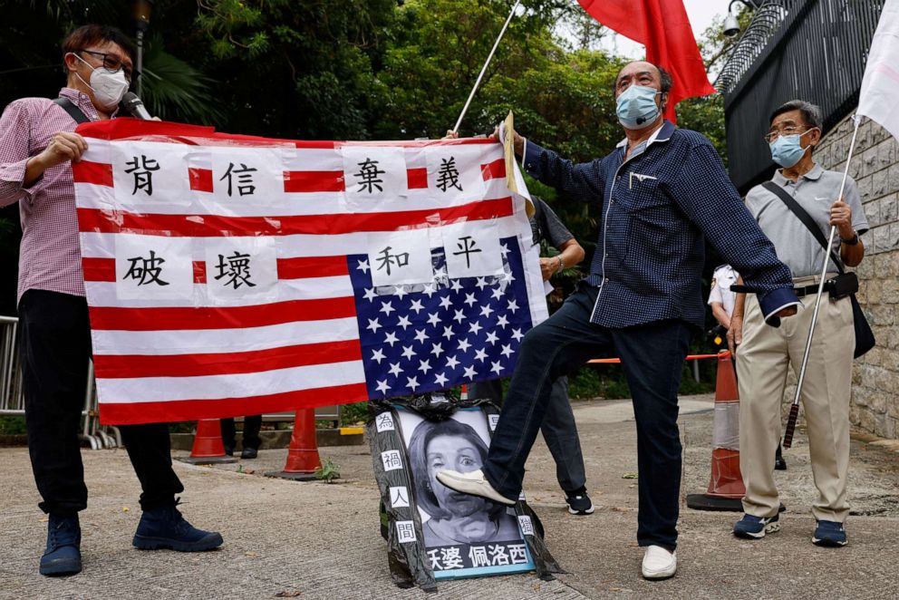 PHOTO: A pro-China supporter steps on a defaced photo of U.S. House of Representatives Speaker Nancy Pelosi during a protest against her visit to Taiwan outside the Consulate General of the United States in Hong Kong, China, Aug. 3, 2022. 