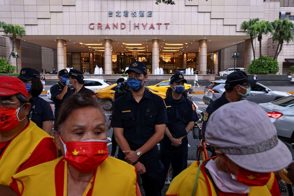 PHOTO: Police officers stand guard outside the Grand Hyatt hotel as demonstrators take part in a protest against U.S. House Speaker Nancy Pelosi's potential visit, in Taipei, Taiwan, Aug. 2, 2022.