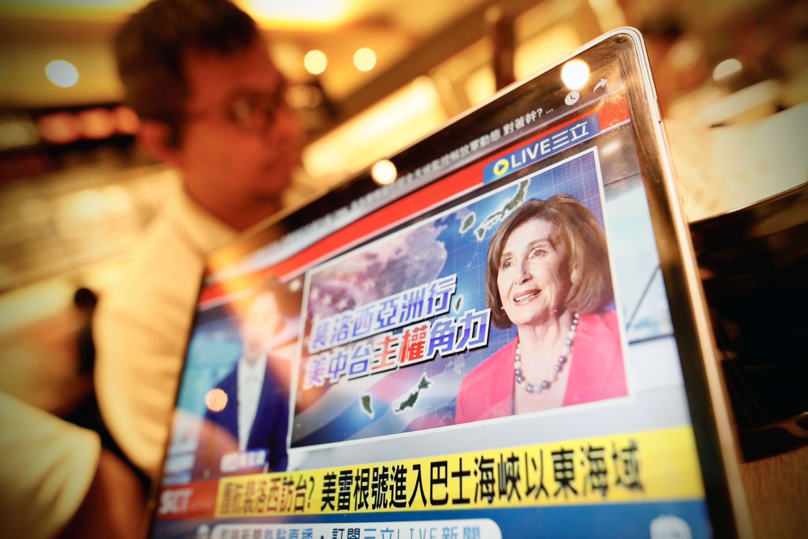 PHOTO: A person watches a news channel about the potential visit of U.S. House Speaker Nancy Pelosi in Taipei, Taiwan, Aug. 2, 2022.