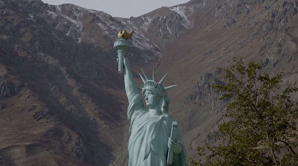 PHOTO:  A replica of the Statue of Liberty stands in a children's park on the Tajikistan side of the border, looking across at Afghanistan.