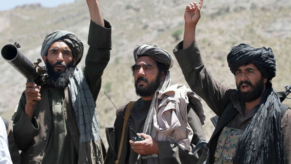 PHOTO: Taliban fighters react to a speech by a senior leader of a breakaway faction of the Taliban, Mullah Abdul Manan Niazi, in the Shindand district of Herat province, Afghanistan, May 27, 2016.