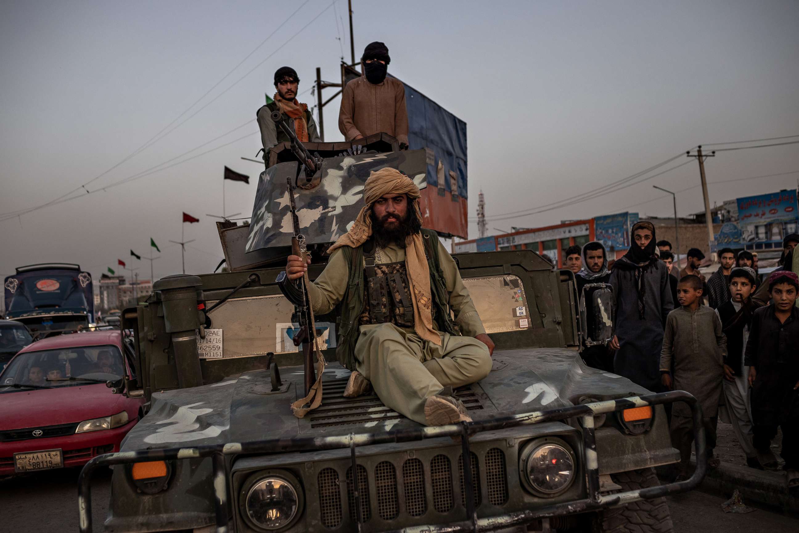 PHOTO: Taliban fighters ride atop a Humvee in Kabul, Sunday, Aug. 15, 2021.