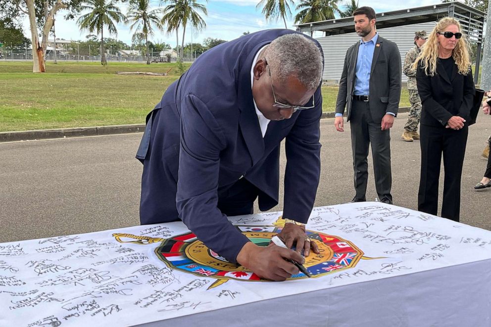 PHOTO: Defense Secretary Lloyd Austin signs a Talisman Sabre Exercise flag after addressing service members from the 13 countries participating in the Talisman Sabre exercise. Austin and Australia’s Deputy Prime Minister Richard Marles