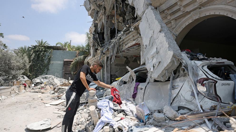 PHOTO: A man looks at items found in the rubble of a destroyed home in the northern Arab-Israeli city of Tamra, on June 24, 2025, days after after an Iranian ballistic missile slammed into the neighbourhood.
