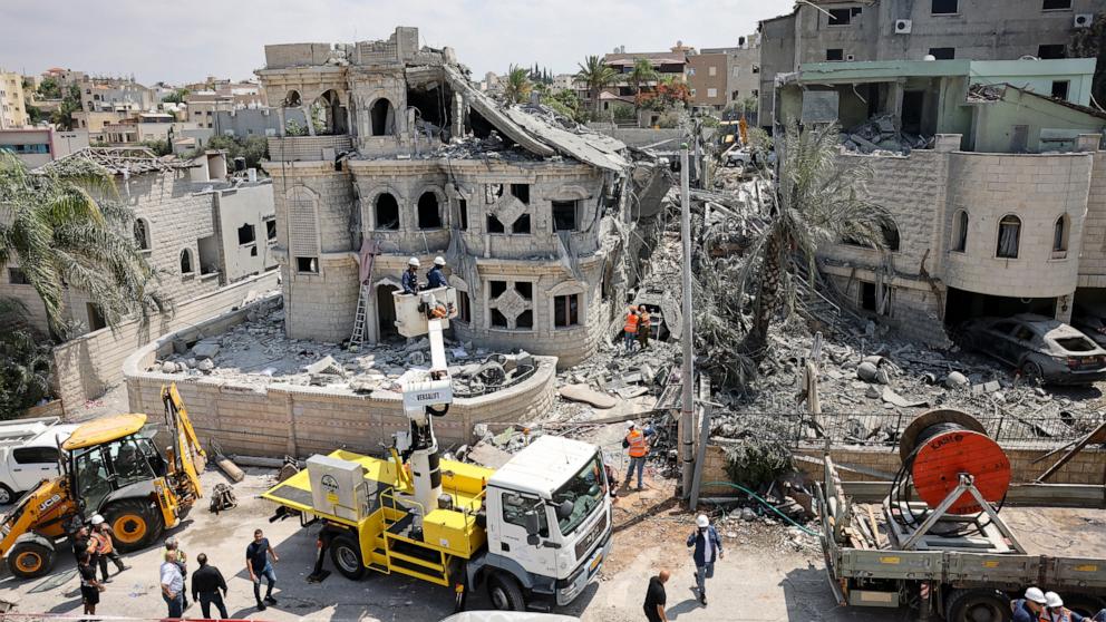 PHOTO: Rescue teams clear rubble in a neighbourhood in the northern Israeli village of Tamra, following an overnigh missile attack from Iran on June 15, 2025, where four people, including a child, were reported killed.