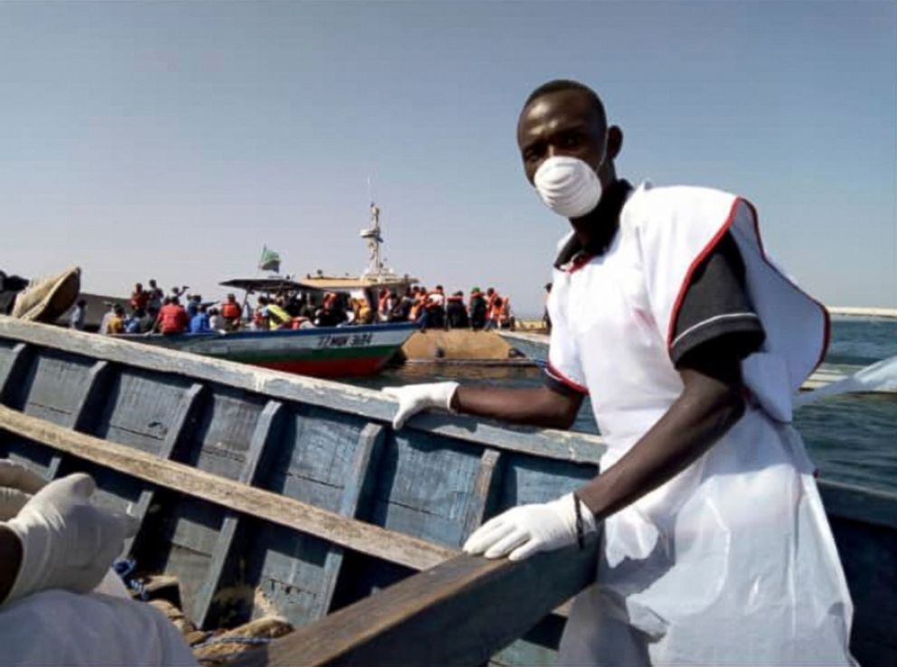 PHOTO: This photo released by the Tanzania Red Cross shows Red Cross volunteers engaged in rescue efforts on and around Ukara Island in Lake Victoria, Tanzania, Sept. 21, 2018.