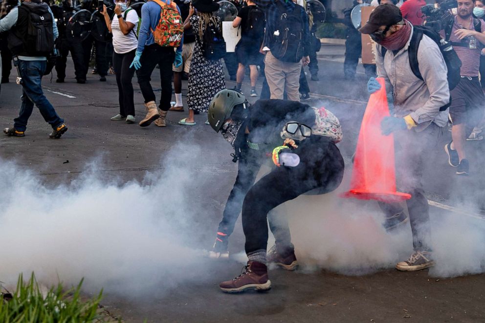 PHOTO: A protester throws back a gas canister towards the police line during a demonstration over the death of George Floyd, who died in police custody, near the White House in Washington, June 1, 2020.