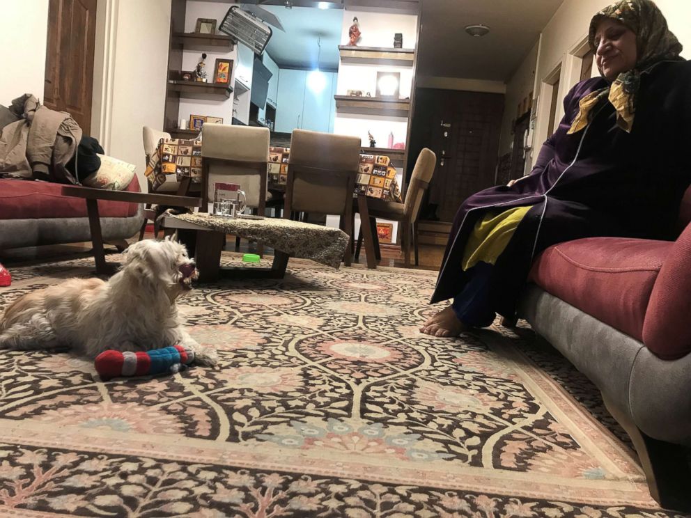 PHOTO: A woman sits with her daughter's dog in an apartment in Tehran, Iran, Jan. 31, 2019.