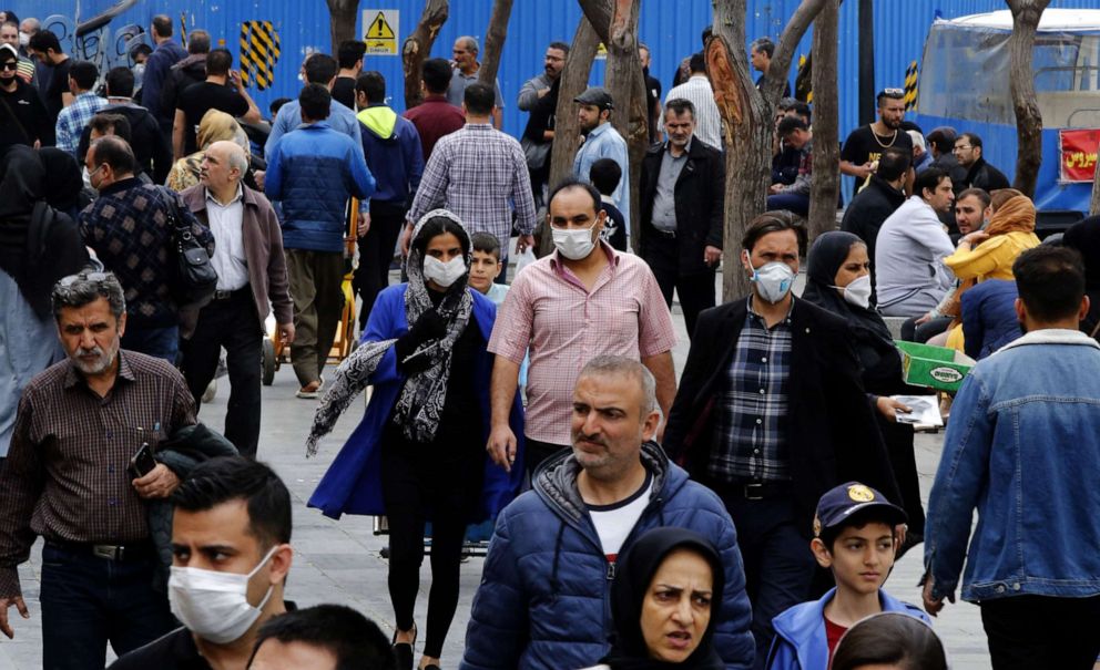 PHOTO: Iranians, some wearing protective masks, gather inside the capital Tehran's grand bazaar during a pandemic of the novel coronavirus on March 18, 2020.