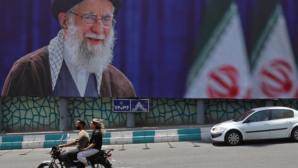 PHOTO: Motorists ride past a giant billboard bearing a picture of Iran's late supreme leader Ayatollah Ali Khamenei ahead of his funeral, in Tehran on July 2, 2026.