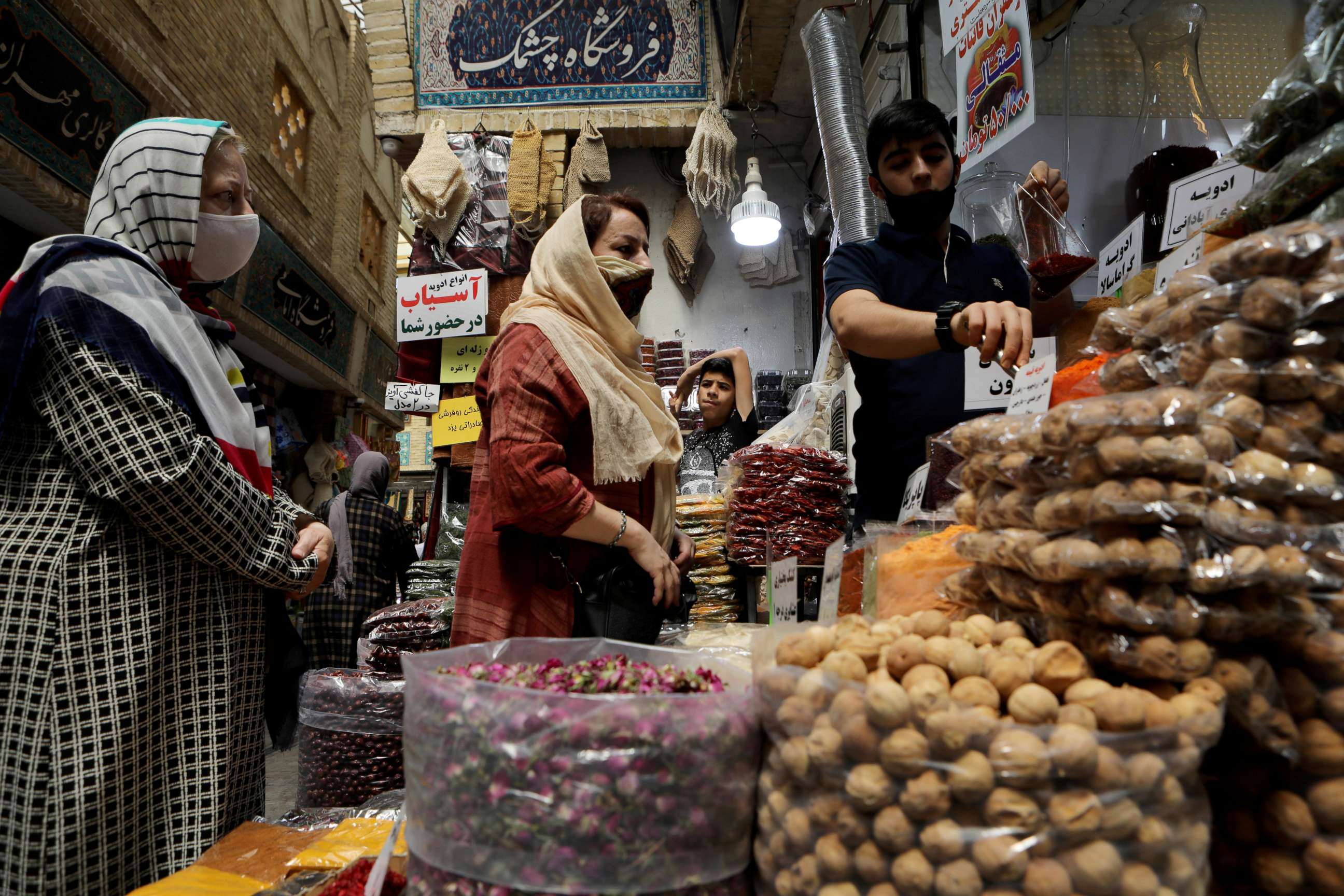 PHOTO: Women wearing protective face masks shop at a bazaar following the outbreak of the coronavirus disease (COVID-19), in Tehran, Iran, July 8, 2020.