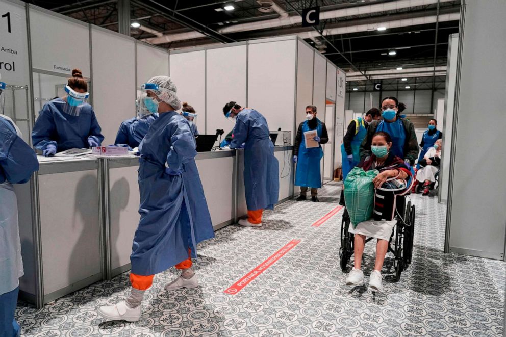 PHOTO: This handout picture released by Madrid's regional government on March 31, 2020, shows health care workers at a temporary hospital for COVID-19 patients located at the IFEMA convention and exhibition center in Madrid, Spain.