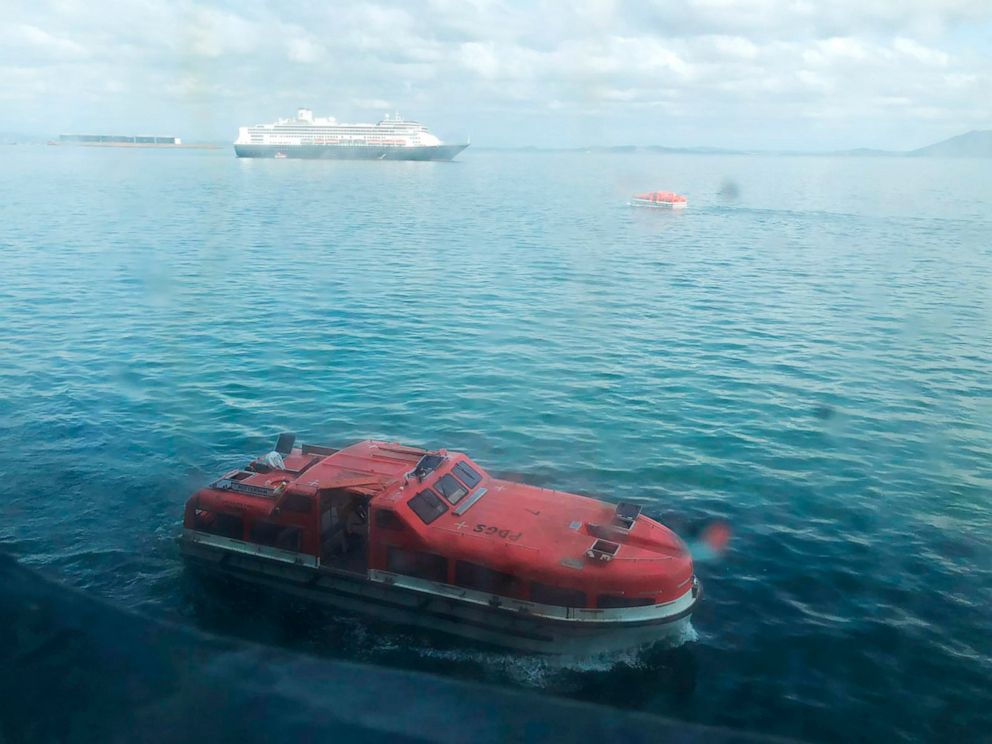 PHOTO: In this March 28, 2020 photo made available by Juan Huergo, a tender approaches the MS Zaandam cruise ship off the coast of Panama. The tender transferred passengers from the MS Zaandam to another cruise ship, the MS Rotterdam (background).
