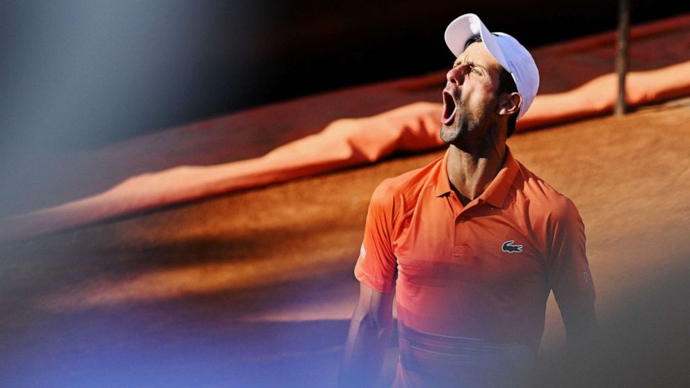 PHOTO: Serbia's Novak Djokovic celebrates winning a game during the final match of the Men's ATP Rome Open tennis tournament against Greece's Stefanos Tsitsipas in Rome, May 15, 2022.