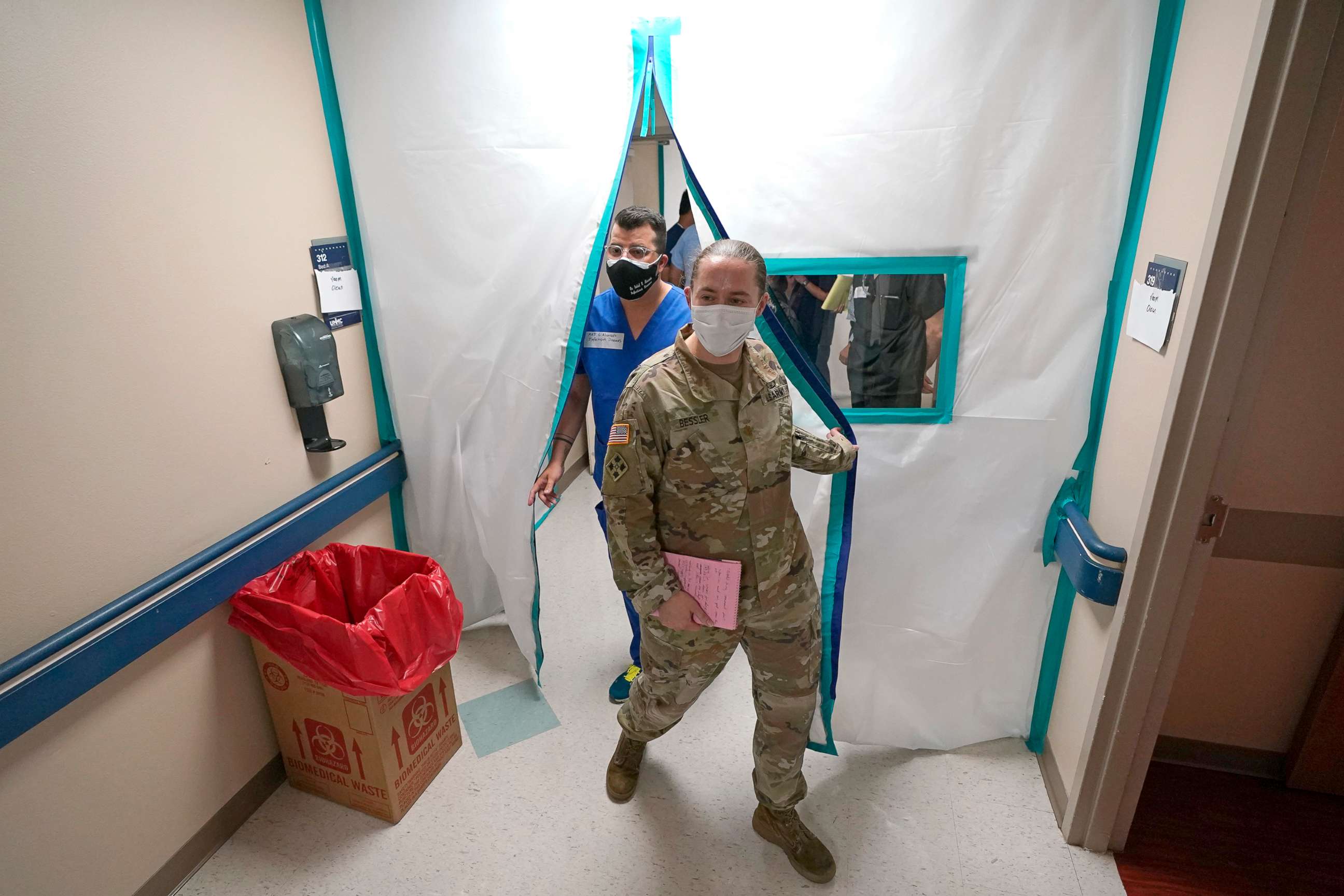 PHOTO: Urban Augmentation Medical Task Force members Army Maj. Katie Bessler, right, and Infectious Disease Physician Maj. Gadiel Alvarado, enter a wing at United Memorial Medical Center in Houston, July 16, 2020.