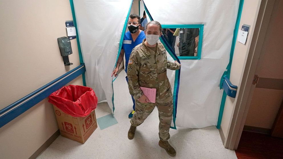 PHOTO: Urban Augmentation Medical Task Force members Army Maj. Katie Bessler, right, and Infectious Disease Physician Maj. Gadiel Alvarado, enter a wing at United Memorial Medical Center in Houston, July 16, 2020.