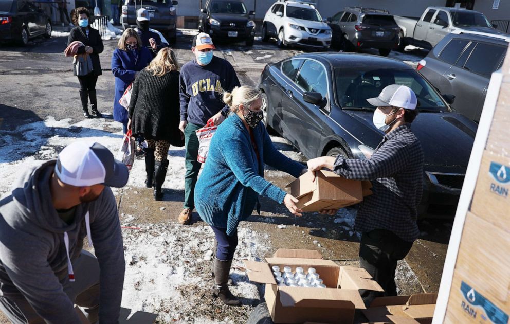 PHOTO: Mark Majkrzak gives out bottles of Rain Pure Mountain Spring Water to people in need on Feb. 19, 2021, in Austin, Texas. Majkrzak, the founder of the company, said he drove from Georgia to deliver water.