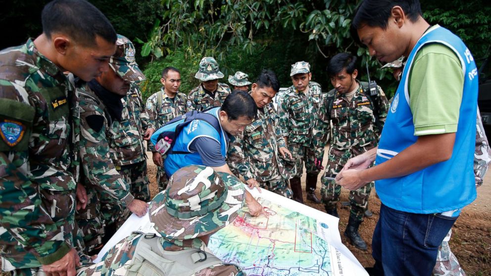 PHOTO: Thai forest rangers examine a map to view possible drilling options during the ongoing rescue operations for the child soccer team and their assistant coach, in Chiang Rai province, Thailand, July 7, 2018.