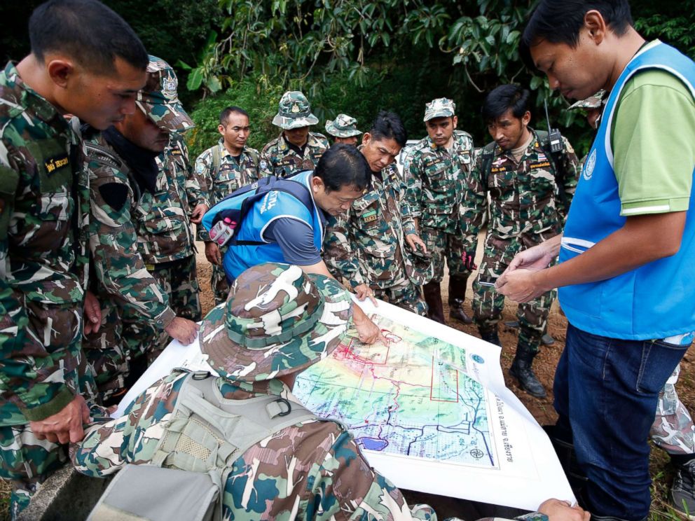 PHOTO: Thai forest rangers examine a map to view possible drilling options during the ongoing rescue operations for the child soccer team and their assistant coach, in Chiang Rai province, Thailand, July 7, 2018.