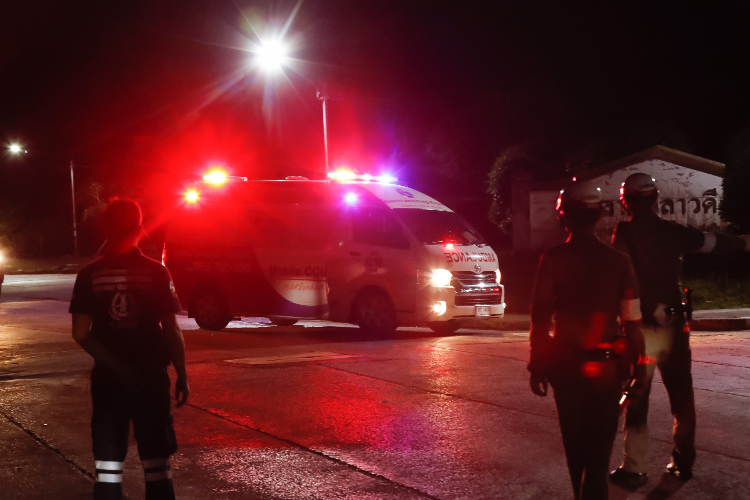 An ambulance believed to be carrying one of the rescued boys from the flooded cave heads to the hospital in Chiang Rai as divers evacuated some of the 12 boys and their coach trapped at Tham Luang cave, northern Thailand, Monday, July 9, 2018.