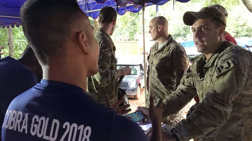 PHOTO: A U.S. military rescue team is briefed by the Thai Navy SEALs at the staging area outside the Tham Luang Nang Non cave in Mae Sai, Chiang Rai province, northern Thailand Thursday, June 28, 2018.