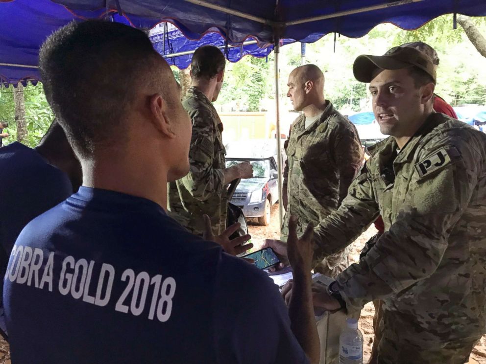PHOTO: A U.S. military rescue team is briefed by the Thai Navy SEALs at the staging area outside the Tham Luang Nang Non cave in Mae Sai, Chiang Rai province, northern Thailand Thursday, June 28, 2018.