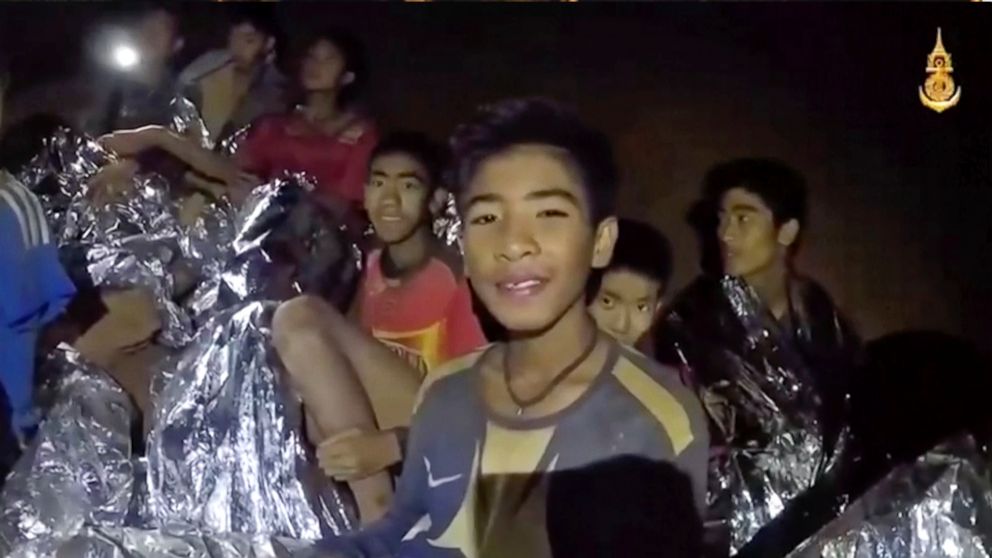 PHOTO: In this July 3, 2018, image taken from video provided by the Royal Thai Navy Facebook Page, Thai boys smile as Thai Navy Seal medic help injured children inside a cave in Mae Sai, northern Thailand.