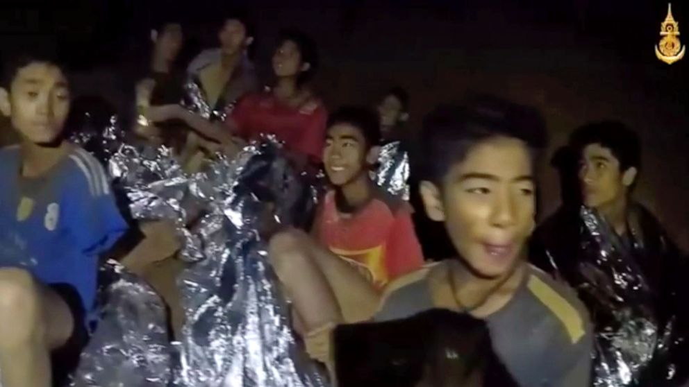 PHOTO: In this July 3, 2018, image taken from video provided by the Royal Thai Navy Facebook Page, Thai boy smiles as Thai Navy SEAL medic help injured children inside a cave in Mae Sai, northern Thailand.