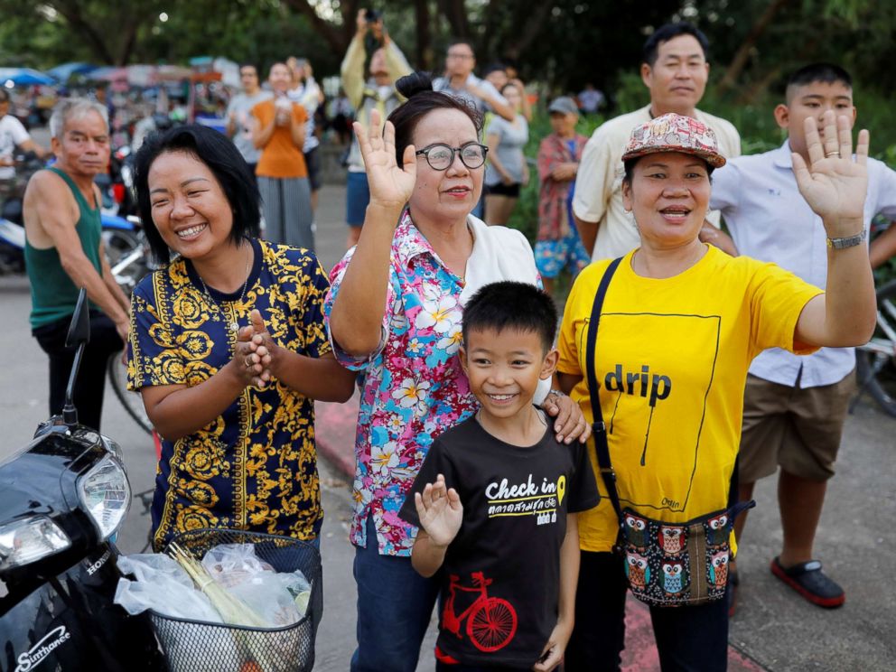 PHOTO: Onlookers wave as an ambulance carrying rescued schoolboys leaves a military airport in Chiang Rai, Thailand, July 10, 2018.