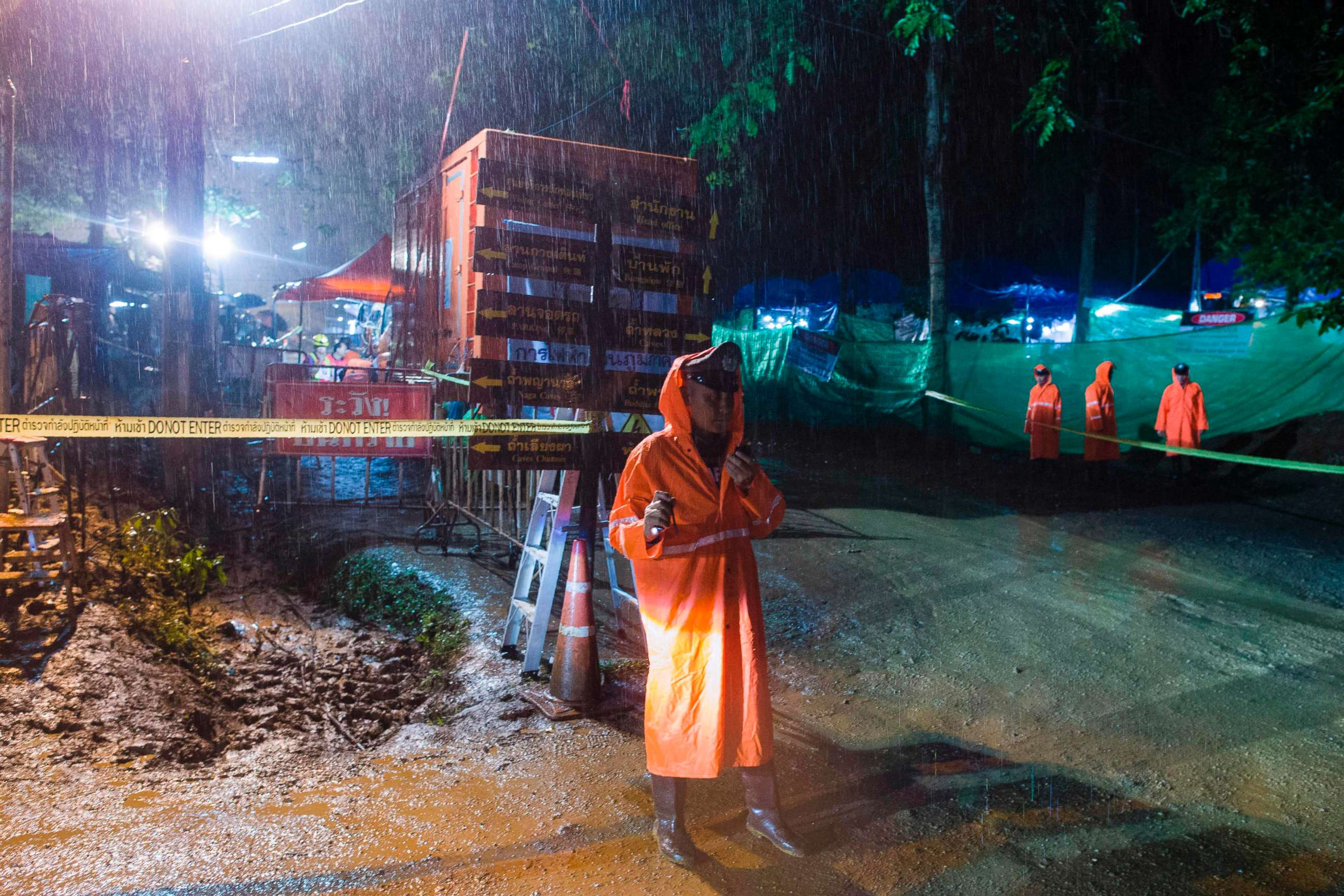 PHOTO: A Thai policeman guards an area under rainfall near the Tham Luang cave at the Khun Nam Nang Non Forest Park in Mae Sai district of Chiang Rai province, July 7, 2018, as rescue operation continues for the 12 boys and their football team coach.