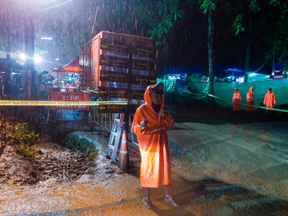PHOTO: A Thai policeman guards an area under rainfall near the Tham Luang cave at the Khun Nam Nang Non Forest Park in Mae Sai district of Chiang Rai province, July 7, 2018, as rescue operation continues for the 12 boys and their football team coach.