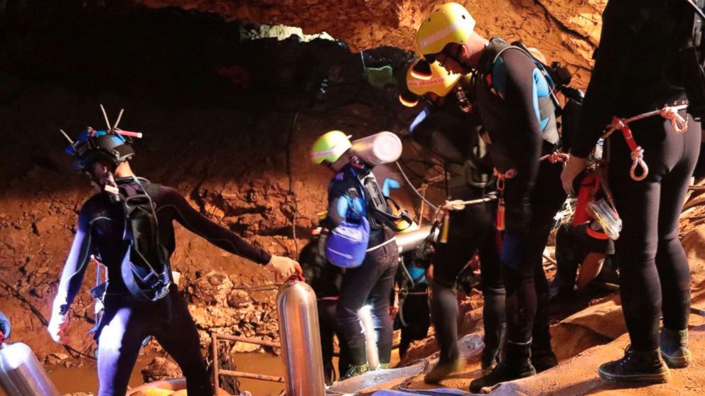 PHOTO: Thai rescue team members walk inside a cave where 12 boys and their soccer coach have been trapped since June 23, in Mae Sai, Chiang Rai province, northern Thailand in this undated photo released by Royal Thai Navy, July 7, 2018.