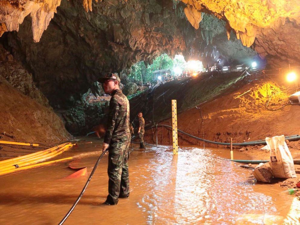   PHOTO: Thai rescue teams are organizing a pumping system at the entrance of a flooded cave complex where 12 boys and their coach have been trapped since June 23 in Mae Sai, in Chiang Rai Province. 