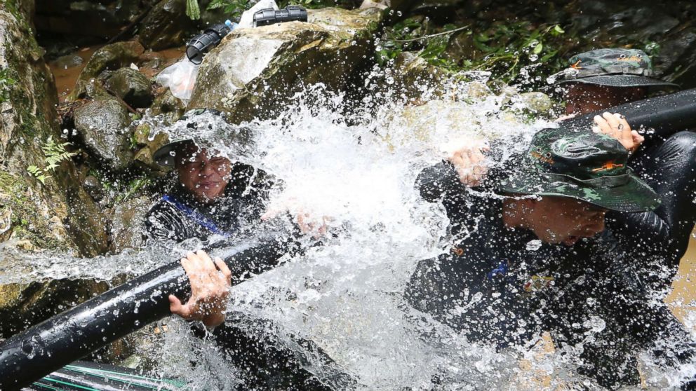 PHOTO: Thai soldiers try to connect water pipes that will help bypass water from entering a cave where 12 boys and their soccer coach have been trapped since June 23, in Mae Sai, Chiang Rai province, in northern Thailand, July 7, 2018.