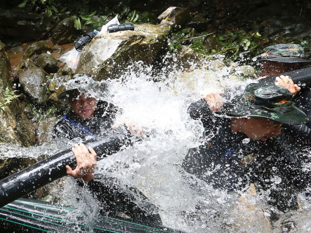 PHOTO: Thai soldiers try to connect water pipes that will help bypass water from entering a cave where 12 boys and their soccer coach have been trapped since June 23, in Mae Sai, Chiang Rai province, in northern Thailand, July 7, 2018. 