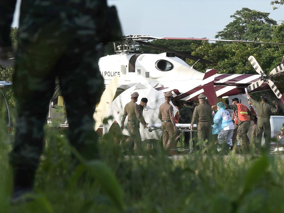 PHOTO: Rescue workers bring a stretcher close to a police helicopter at a military airport in Chiang Rai on July 9, 2018, as rescue operations continue for those still trapped inside the cave in Khun Nam Nang Non Forest Park in the Mae Sai district.