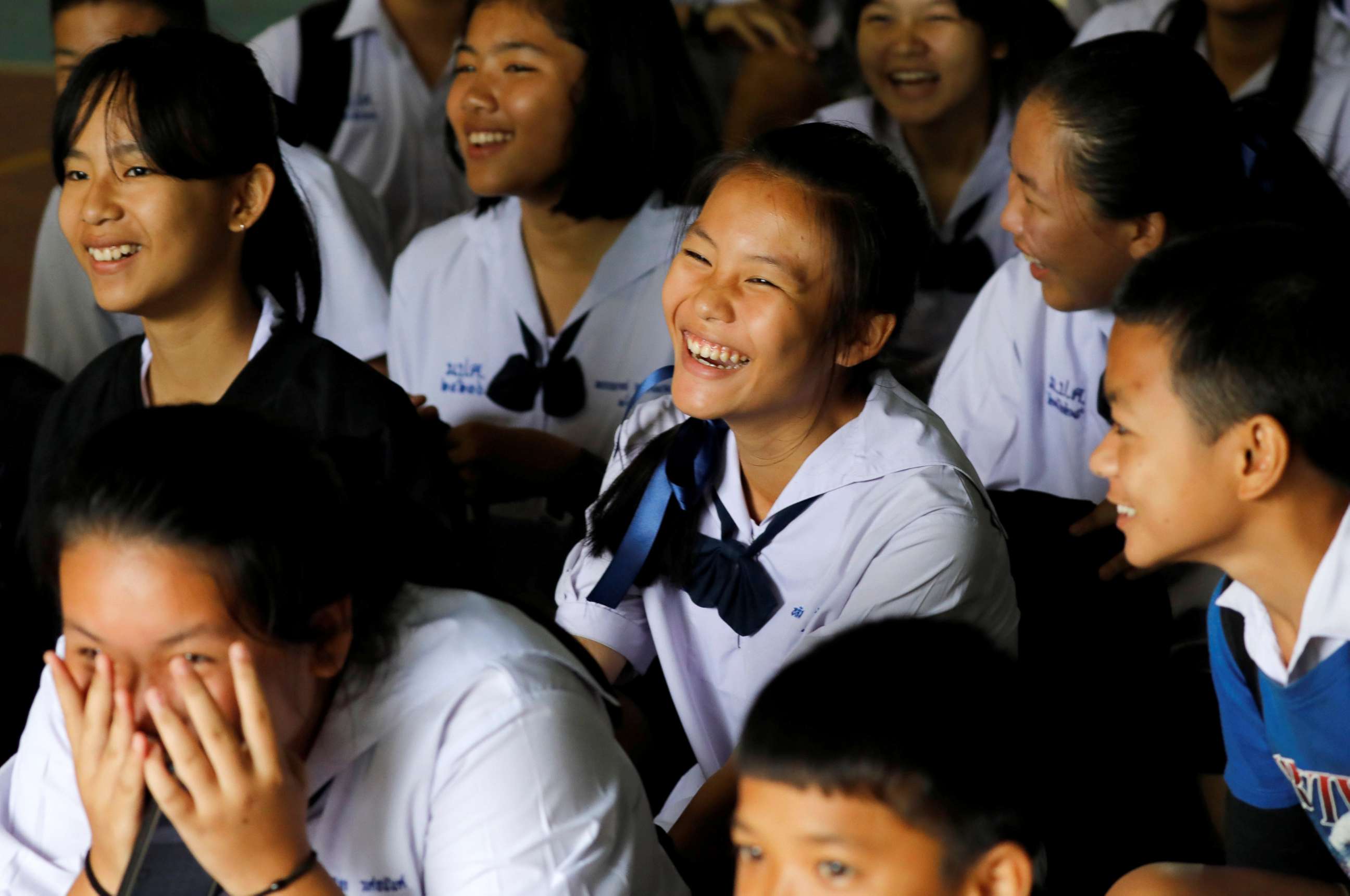 PHOTO: Classmates react after a teacher announces that some of the 12 schoolboys who were trapped inside a flooded cave, have been rescued, at Mae Sai Prasitsart school,  in the northern province of Chiang Rai, Thailand, July 9, 2018.