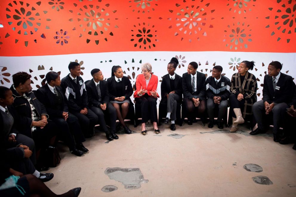 PHOTO: Britain's Prime Minister Theresa May talks to a group of school children during a visit to the ID Mkhize Secondary School in Gugulethu, as part of a working visit to South Africa, Aug. 28, 2018.